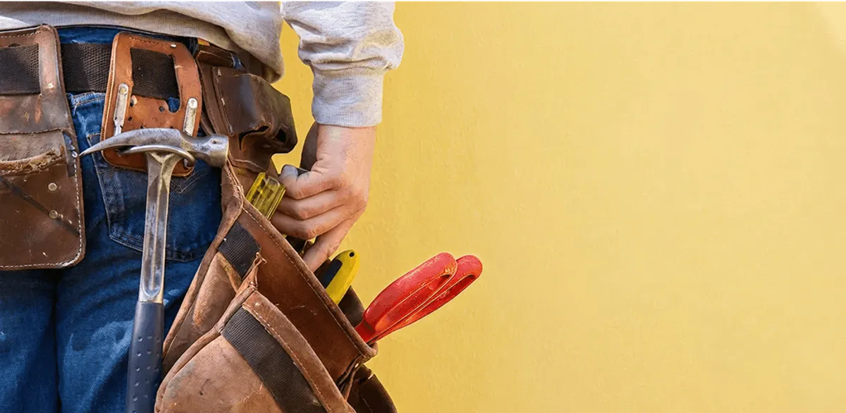 Handyman with tool belt ready for home repairs and maintenance in Orange, CA